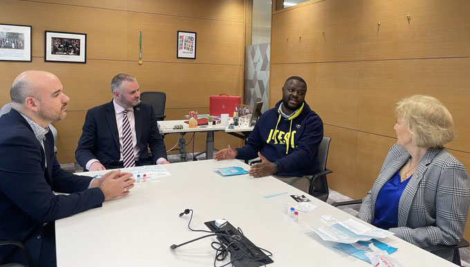 Health ministers Andrea Leadsom and Andrea Stephenson with Richard Angell and Taku Mukiwa sat round a table