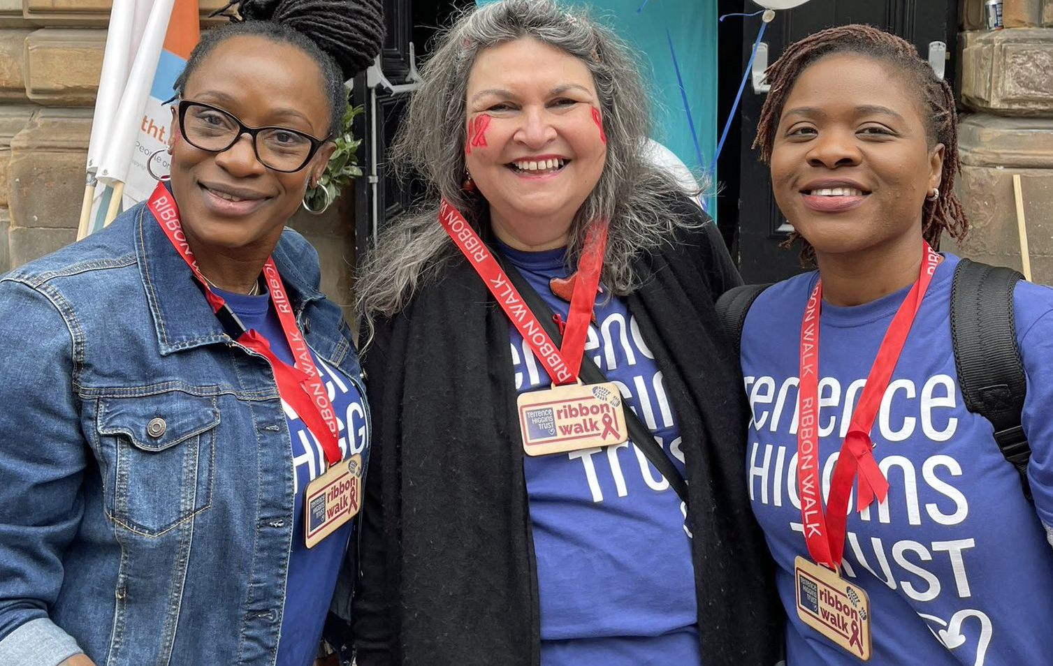 Three people with Ribbon Walk medals