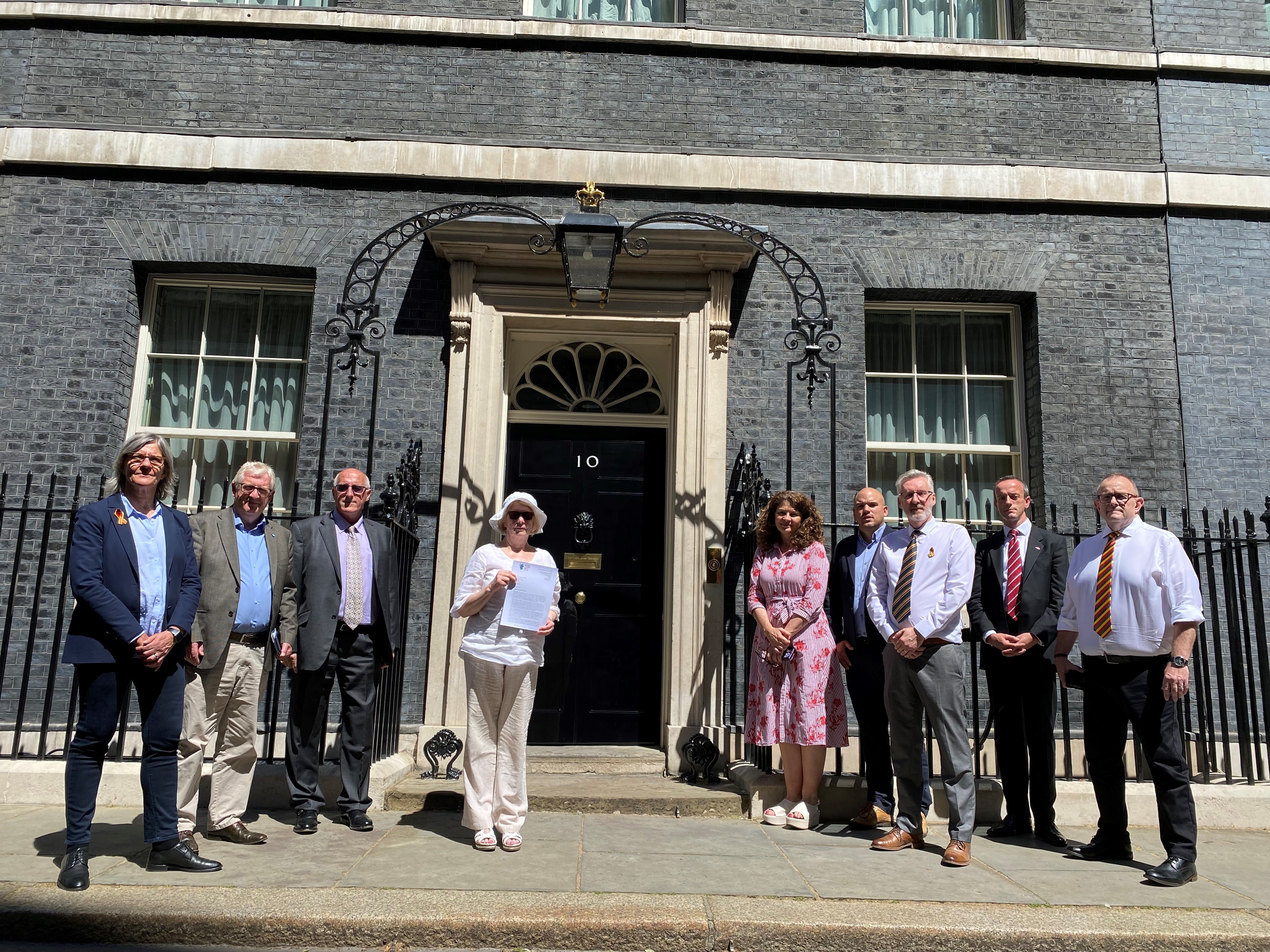 Representatives of multiple organisations outside 10 Downing Street with letter to Prime Minister