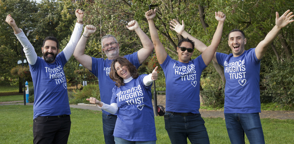 Group posing in THT shirts in a park