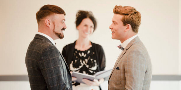 Two newly married men in front of registrar