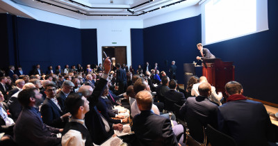 Seated crowd looking at auctioneer