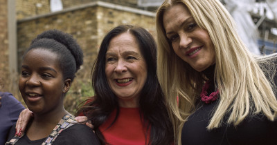 Three women smiling