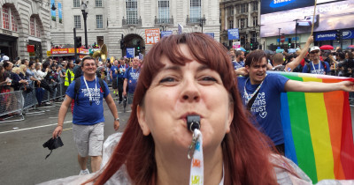 Woman blowing whistle at London Pride